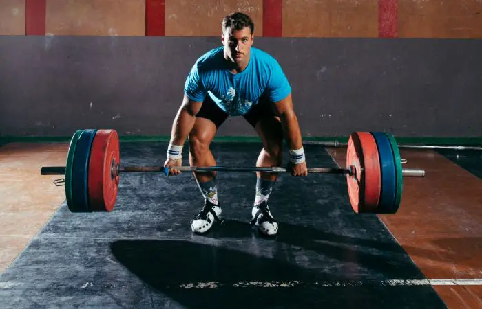 A man is lifting some heavy barbells