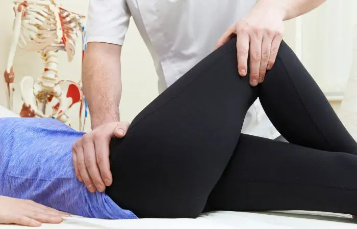 A person is stretching their legs on the bed