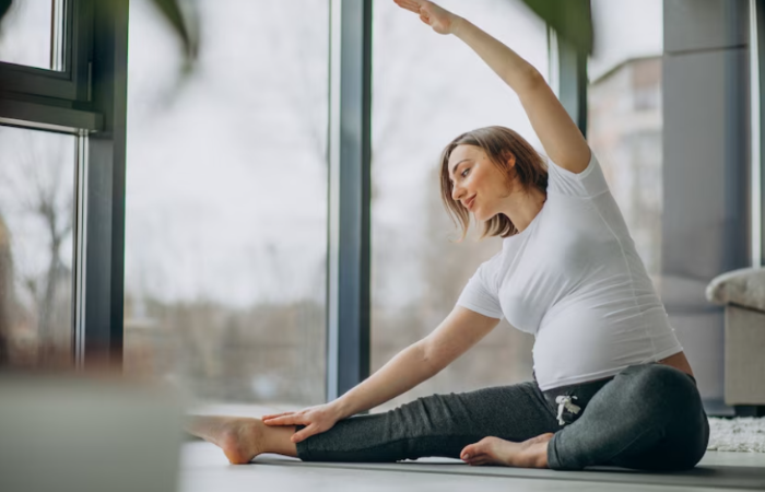 A woman is doing yoga on the floor