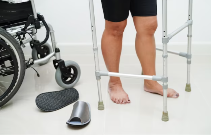 A man standing next to a walker and walking frame.